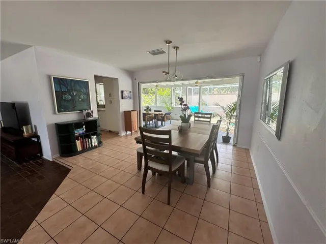 Dining space featuring visible vents and light tile patterned floors