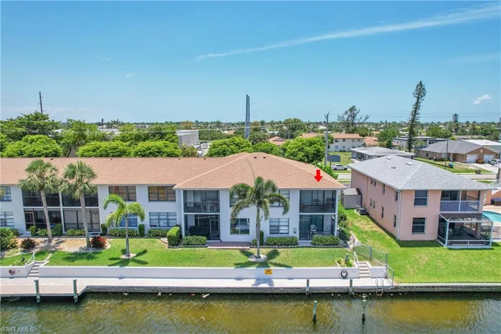 Aerial view of residential area featuring a nearby body of water