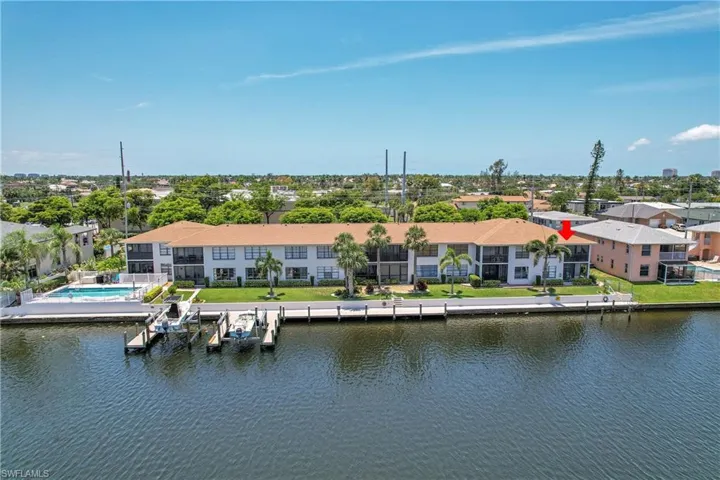 Aerial perspective of suburban area featuring a nearby body of water