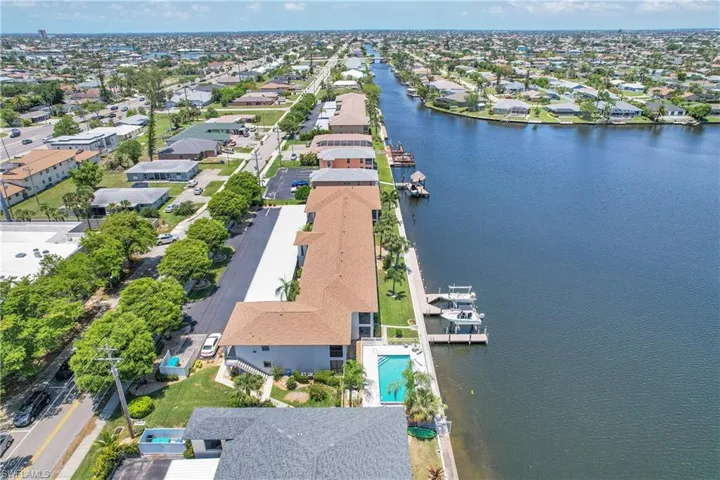 Aerial perspective of suburban area featuring a nearby body of water