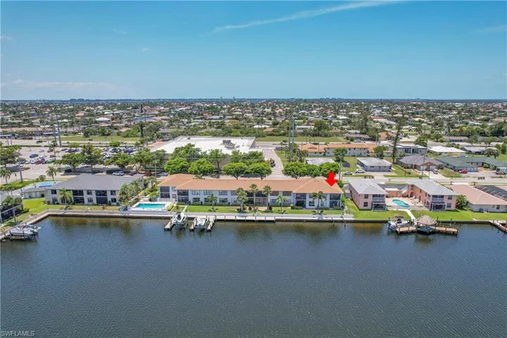 Aerial perspective of suburban area featuring a nearby body of water