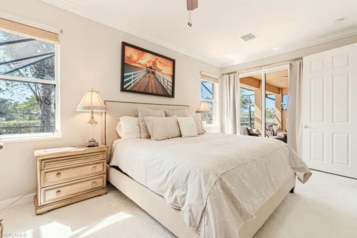 Bedroom featuring access to outside, light colored carpet, a ceiling fan, ornamental molding, and visible vents
