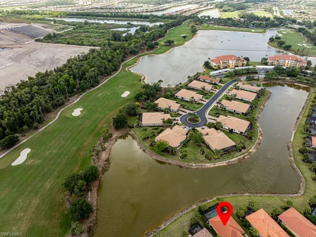 Drone / aerial view featuring a water view, golf course view, and a residential view