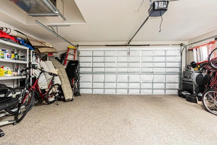 Garage featuring a garage door opener