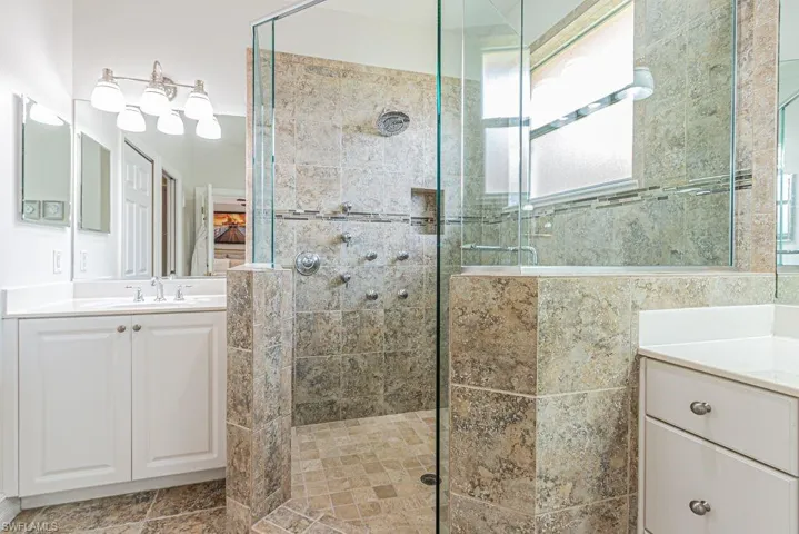 Bathroom featuring a stall shower and vanity