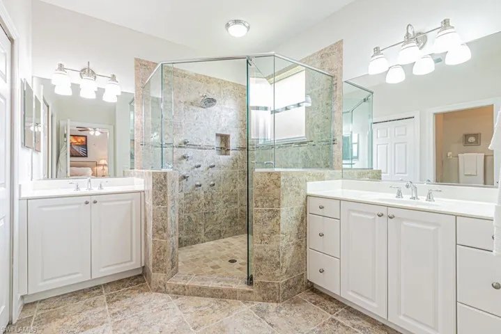 Bathroom with a shower stall, vanity, and ensuite bathroom
