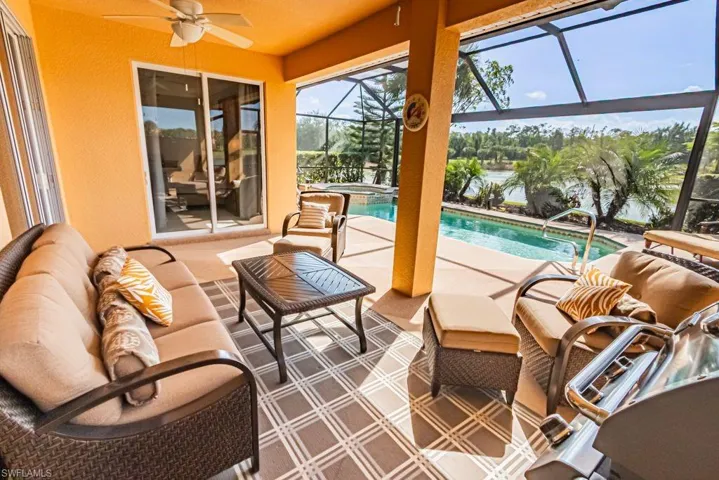 Sunroom / solarium featuring a pool, a ceiling fan, and an outdoor hangout area