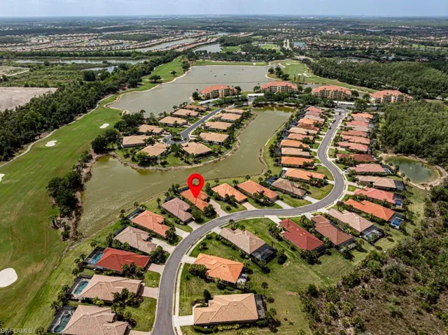 Birds eye view of property featuring golf course view, a residential view, and a water view