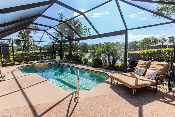 View of pool featuring a lanai, a patio, and a pool with connected hot tub