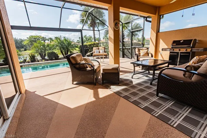Sunroom with a pool and outdoor lounge area