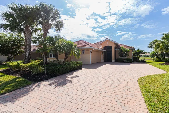 Mediterranean / spanish-style home featuring a tiled roof, a garage, decorative driveway, and stucco siding