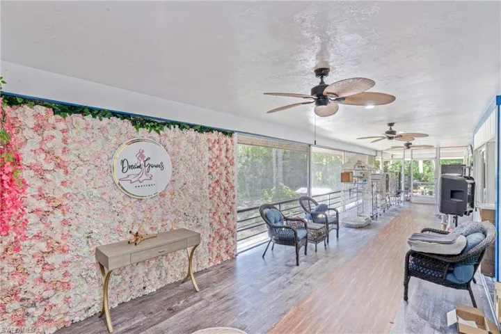 Sunroom / solarium featuring a textured ceiling and wood finished floors