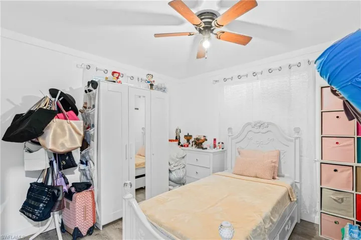 Bedroom with wood finished floors and a ceiling fan