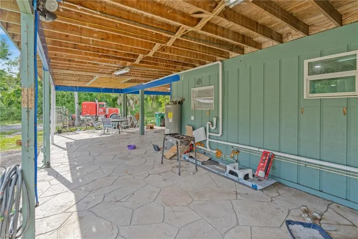 View of patio featuring water heater and outdoor dining area