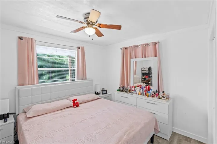 Bedroom with a ceiling fan and light wood-style floors