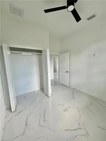Unfurnished bedroom with a closet and ceiling fan