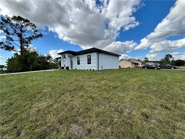 View of side of home featuring a lawn