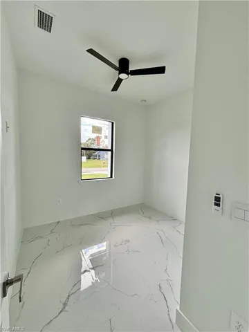 Unfurnished room featuring ceiling fan