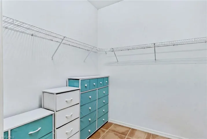 Spacious primary walk-in closet offering ample storage and room to keep everything organized.
