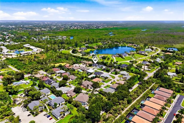 Soaring above the neighborhood, this aerial view captures the charm, convenience, and relaxed Florida lifestyle this home offers.