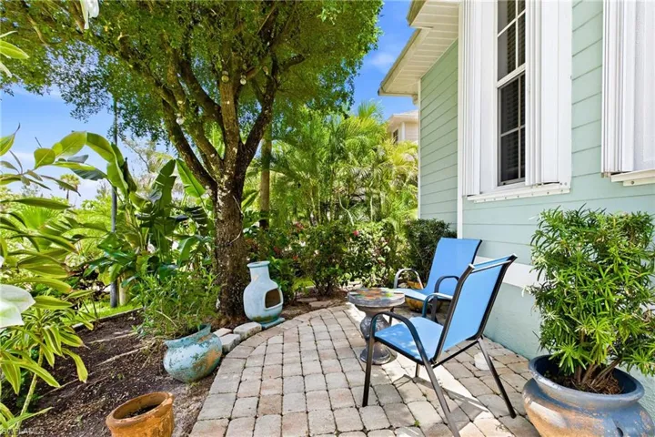 Charming outdoor sitting area offering the perfect spot to relax, enjoy the fresh air, and take in the peaceful backyard surroundings.