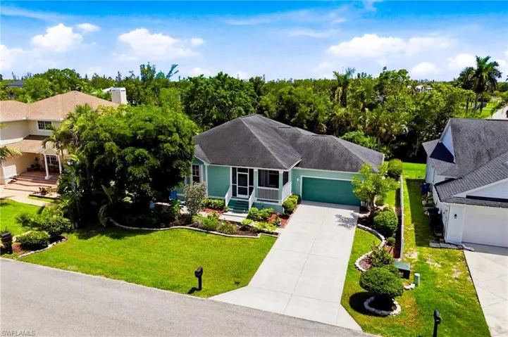 Charming front elevation nestled in a quiet, established neighborhood just minutes from beaches and shopping.