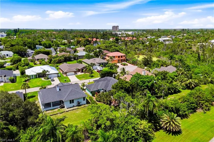 Enjoy the Florida lifestyle from above with this expansive aerial view of the backyard, offering a serene setting for entertaining, relaxing, and creating memories.