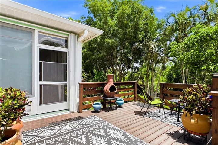 Beautiful deck surrounded by mature landscaping and plenty of shade.