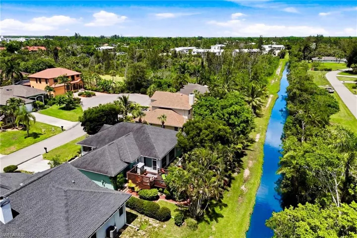 Stunning aerial view showcasing the spacious backyard retreat, beautiful deck oasis, and peaceful outdoor setting.