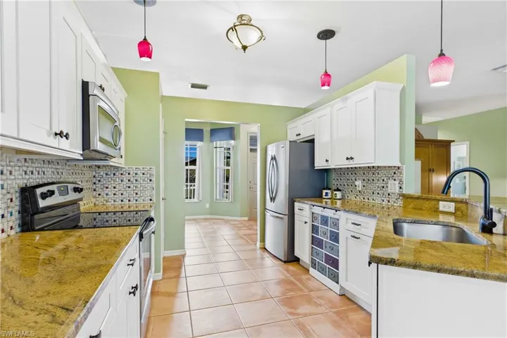 Spacious kitchen featuring stainless steel appliances, abundant cabinetry, and generous counter space.
