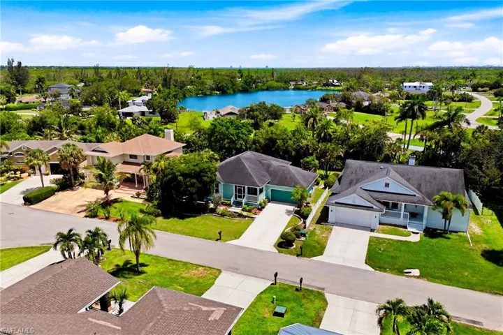 Aerial showcase of the property’s inviting exterior and exceptional location close to beaches, shopping, dining, and everyday conveniences.