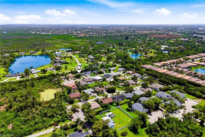 Beautiful aerial view showcasing the home, surrounding greenery, and the quiet residential atmosphere of this sought-after South Fort Myers community.