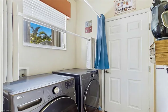 Convenient indoor laundry room with additional storage.