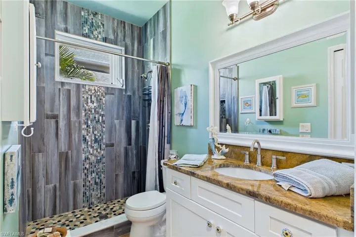 Beautifully updated guest bathroom with coastal-inspired finishes.
