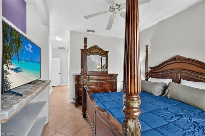 Crown molding, ceiling fan, tile flooring, built-in shelving, and recessed lighting