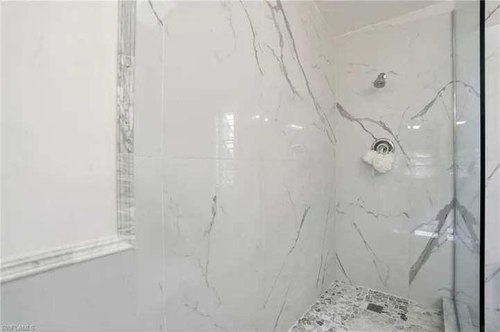 Primary bath beautifully remastered with custom marble and stone finishes