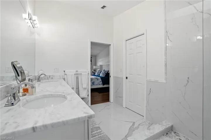 Primary Ensuite bath with double vanity and marble finishes