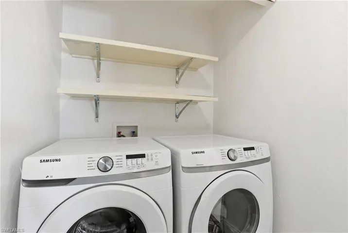 Laundry area with shelving and newer appliances