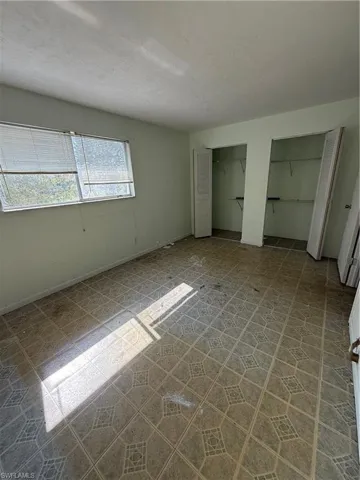Unfurnished bedroom featuring multiple closets