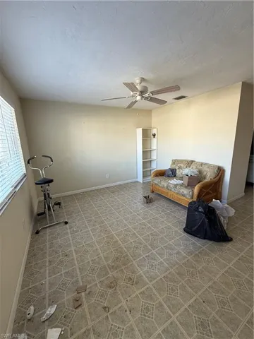 Unfurnished living room with ceiling fan