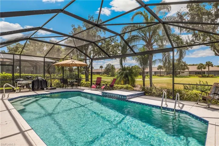 View of swimming pool with a lanai and a patio