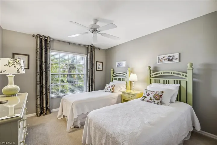 Bedroom featuring ceiling fan and light colored carpet