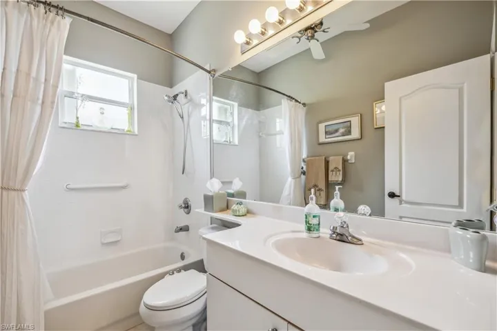 Full bathroom featuring vanity, shower / bath combo with shower curtain, and toilet with bidet
