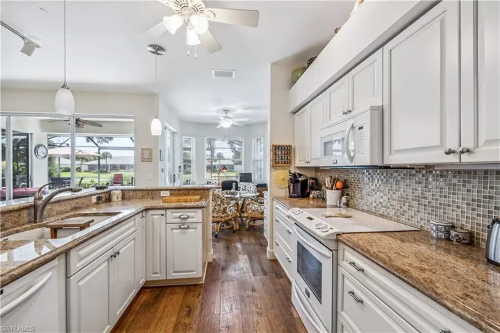 Kitchen with white appliances view of pool from kitchen sink!!