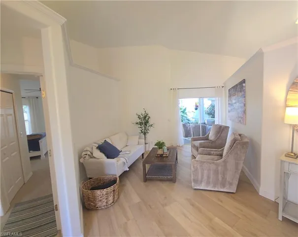 Living room featuring light wood-style flooring and baseboards