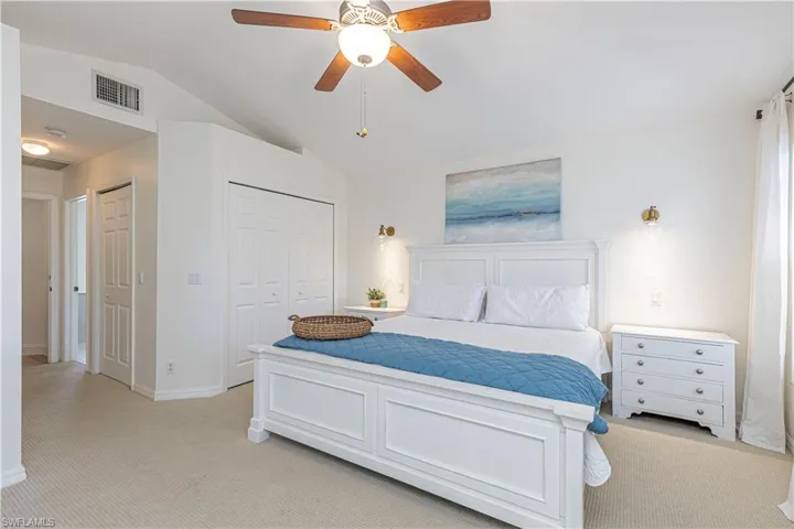 Master suite, new Carpeted bedroom featuring vaulted ceiling, ceiling fan, and walkin closet