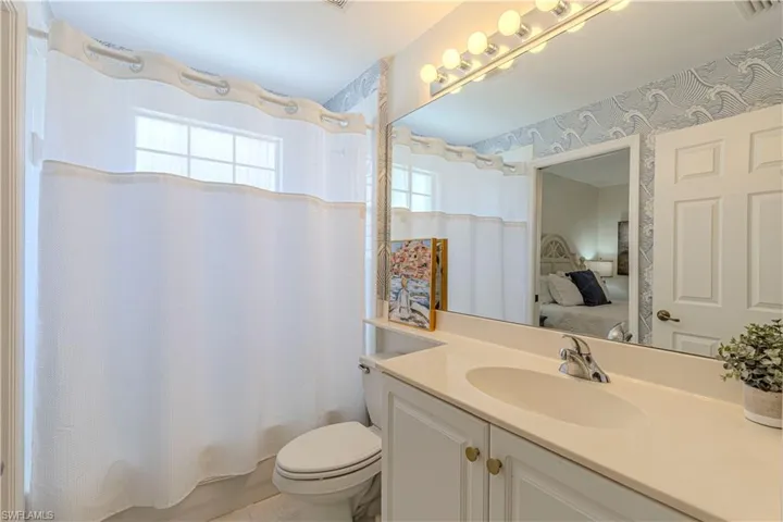 Full bathroom featuring vanity, toilet, and shower / tub combo
