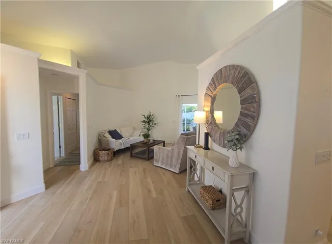 Hall with light wood-style floors and baseboards