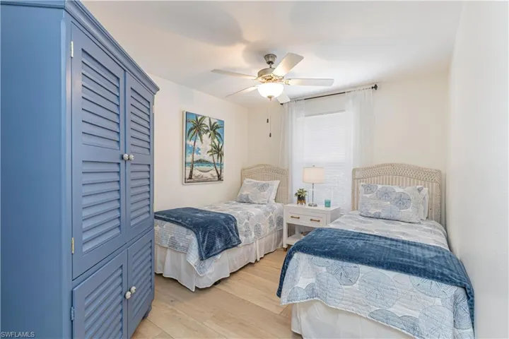 Den/office currently used as 3rd bed. featuring ceiling fan and light hardwood / wood-style floors