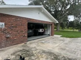 Garage featuring concrete driveway